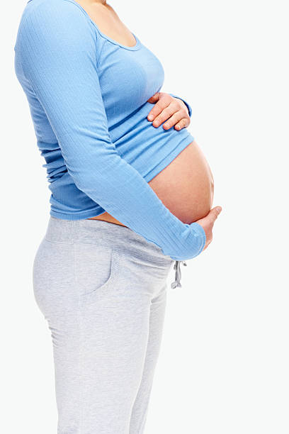 istock Mid section of a pregnant lady isolated on white 182670834