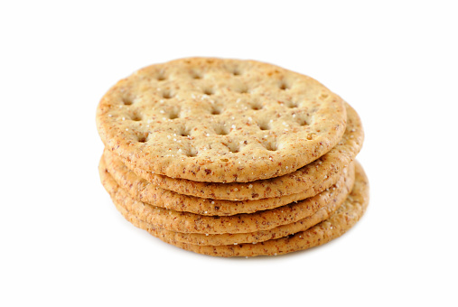 Pile of healthy whole wheat crackers isolated on white. More crackers...