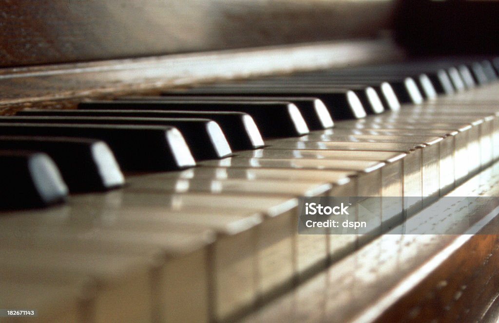 Ivory Mood "Moodily lit macro of an old upright piano keyboard. Narrow DOF, with focus sharp a little right of centre. Slight fim grain (Fuji Velvia)." Light - Natural Phenomenon Stock Photo