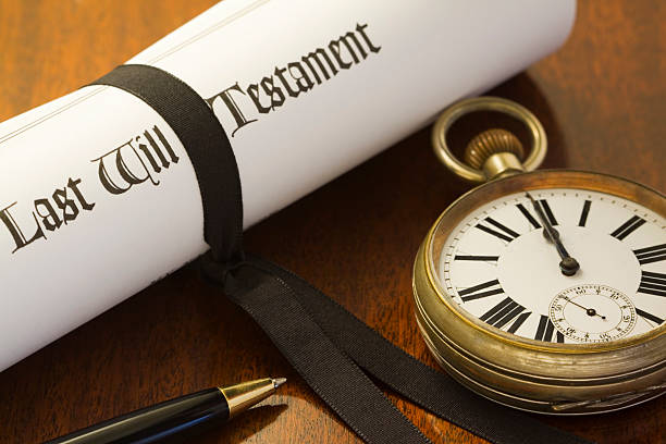 Last Will "When your time comes to an end. A scroll of a Last Will & Testament, tied with a black ribbon on a mahogany desk, with pocket watch set to midnight" probate photos stock pictures, royalty-free photos & images