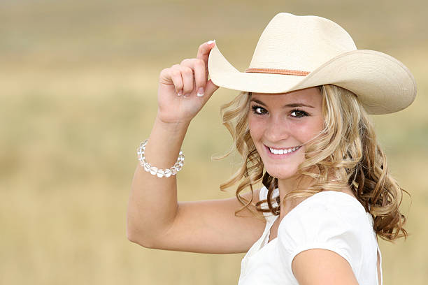 Woman with cowboy hat a a smile. Shallow DOF