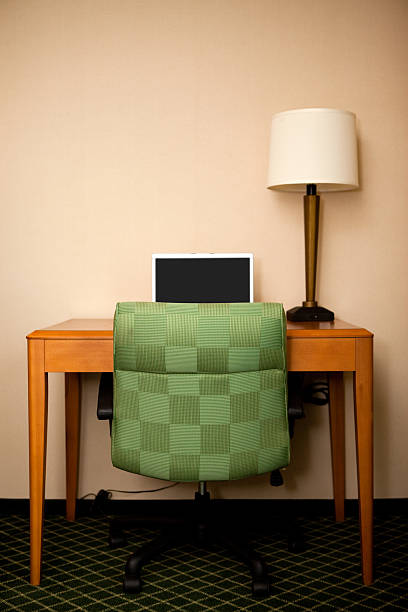 istock Laptop Computer on Desk with Lamp in Hotel Room 182672653