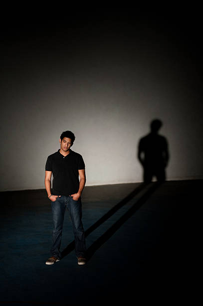 istock Lonely man in a dark room 182672792