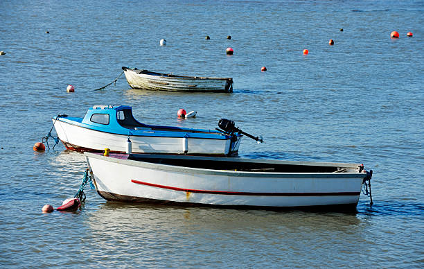 istock Three small boats moored in a Scottish harbour 182672818