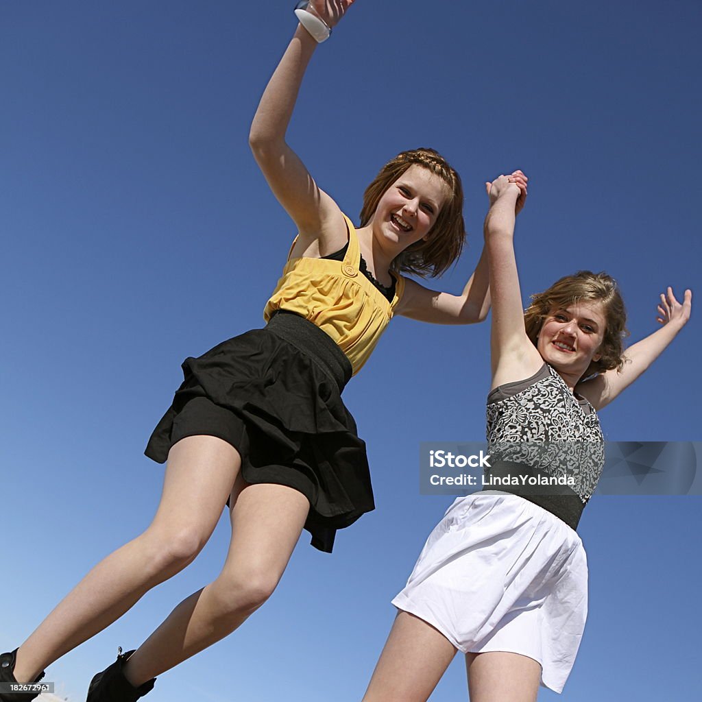 Teen Girls Jumping for Joy Two 13 year old girls jump for joy against a bright blue sky. Copy space. Shot with a Canon 5D Mark II. 12-13 Years Stock Photo