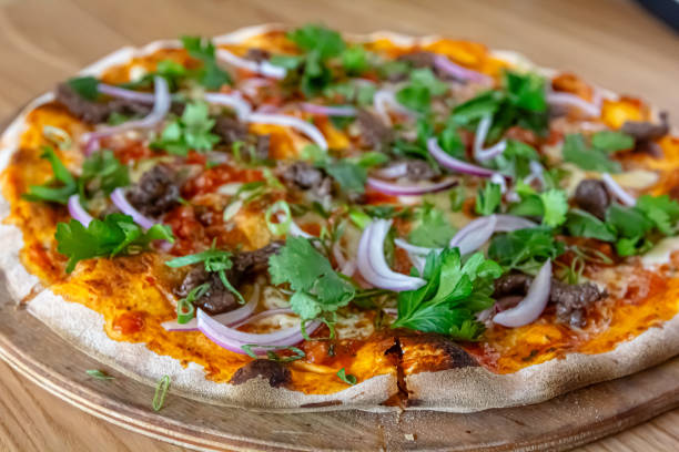 istock delicious steak pizza with beef and onions 1826730351