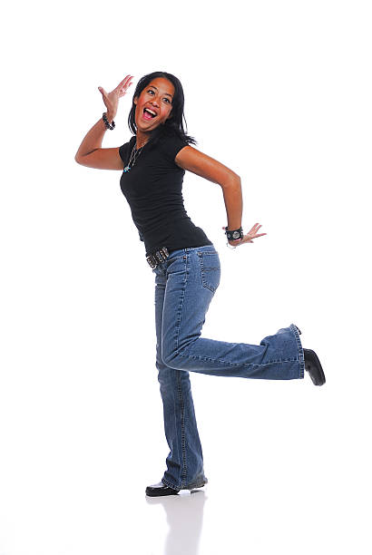 istock Spunky & playful young woman dancing on white background 182673088