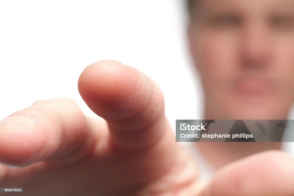 Middle Aged Man Reaching Out Touching the Screen Close up image of a man's hand. He is reaching toward the camera with his finger extended as if he is touching something in front of him. The man's face is in the background but it is unrecognizable due to the shallow depth of field. In Front Of Stock Photo