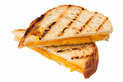 Grilled cheddar on sourdough sandwich isolated on white.
