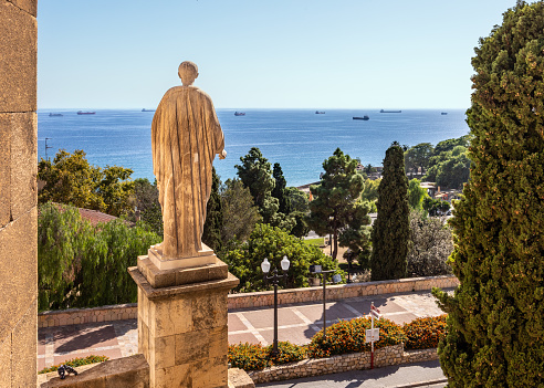 Ancient Roman statue on Mediterranean Balcony in Tarragona with park and ships
