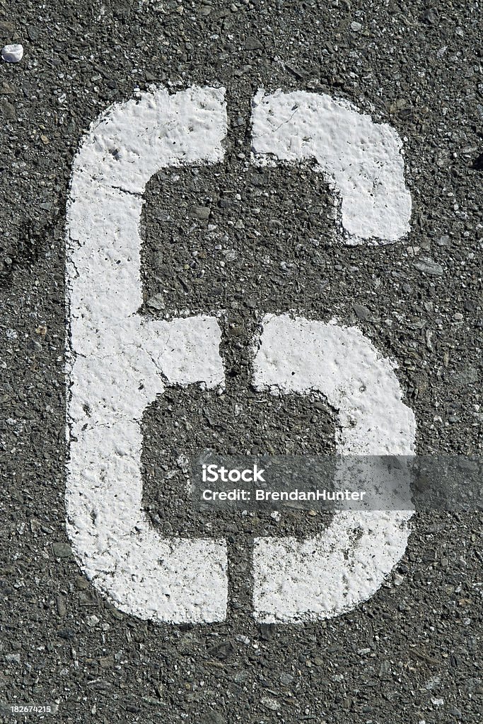 A number 6 stenciled on asphalt. Asphalt Stock Photo
