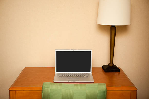 istock Laptop Computer on Desk with Lamp in Hotel Room 182674307