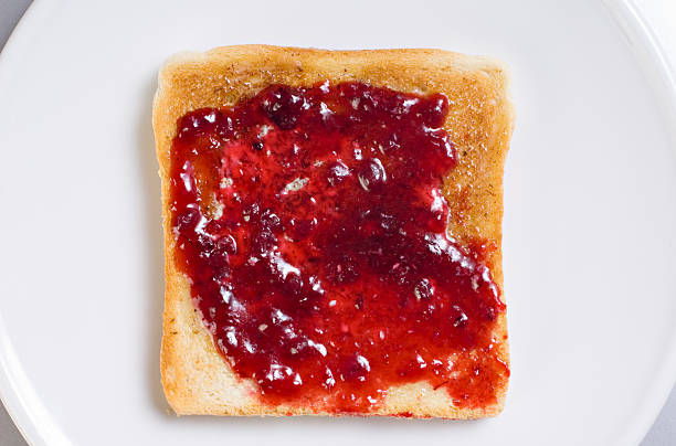 Toast with running strawberry jam