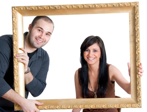 Male and female posing with an empty frame.Please see some similar pictures from this photoshoot: