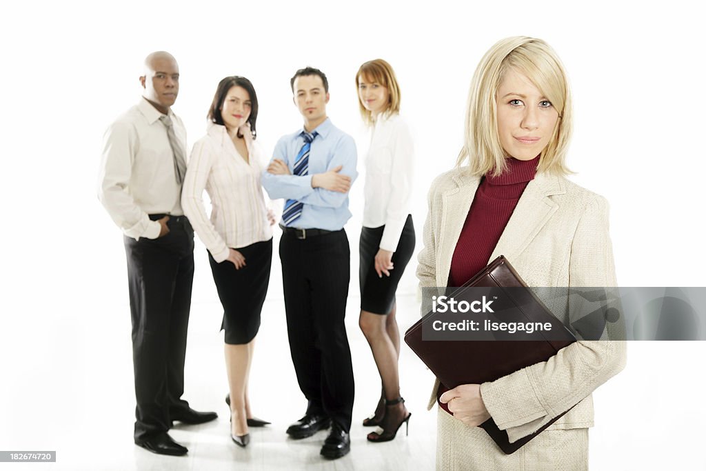 Young woman and her team Focus is on the woman in front. Achievement Stock Photo