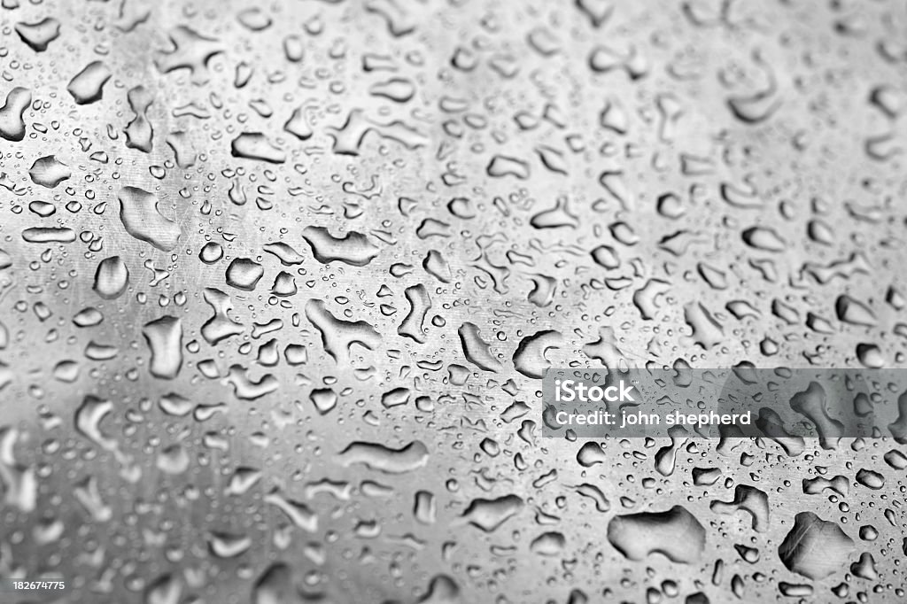 rain water droplets on a metalic surface rain water droplets on a stainless streel background. Art Stock Photo
