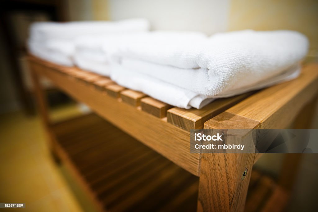 Soft cotton towel in hotel bathroom "Soft cotton towel in hotel bathroom. Shallow DOF, selective focus on edge of closest towel." Bathroom Stock Photo