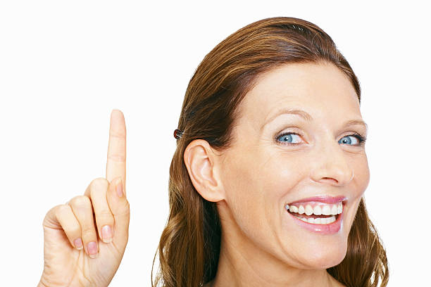 istock Happy woman pointing at copyspace on white 182675136