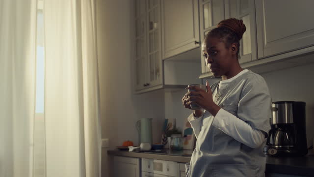African American Medic Drinking Morning Cup of Coffee before Work