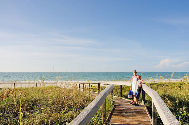 Boy and Girl on Path to Sanibel Island Beach "Please see my lightboxes for more images like this -- Thanks!!!  A young boy and girl pause on the way to the beach on Sanibel Island, Florida.  RAW source image." sanibel island stock pictures, royalty-free photos & images