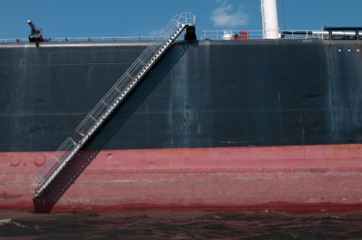 Shipping and Trucking Transportation - RO-RO Transport (Roll On/Roll Off).  Aerial view of Trucks leaving Ro-Ro ship.