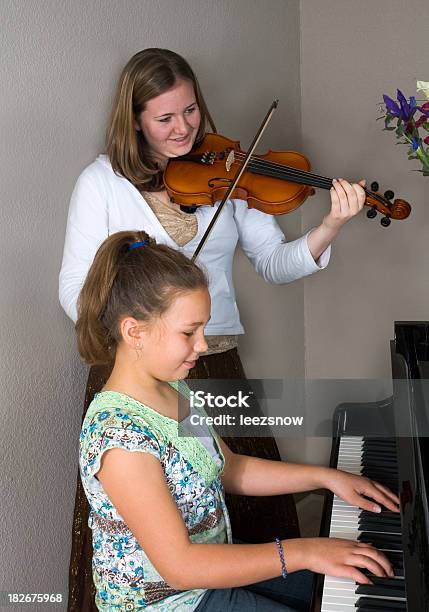Girls Playing Piano And Violin Stock Photo - Download Image Now - Adolescence, Beautiful People, Beauty