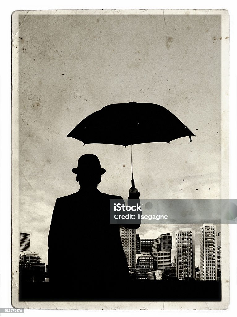 Man with umbrealla on an old paper Many with umbrella on and old paper. Umbrella Stock Photo