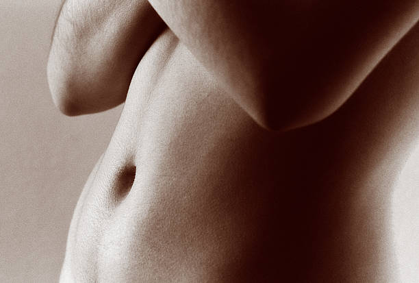 Abdomen "Close-up image of woman's belly, in sepia.Here are some similar images:" female navel stock pictures, royalty-free photos & images