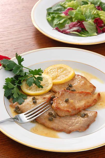 Veal Piccata "A classic Italian veal piccata - veal scaloppine sauteed with white wine, capers, and lemon.More veal piccata, chicken marsala, and chicken piccata:" scaloppini stock pictures, royalty-free photos & images