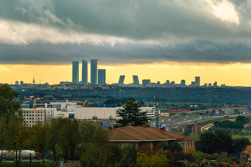 Skyline of the city of Madrid at sunset on a cloudy day with storm clouds