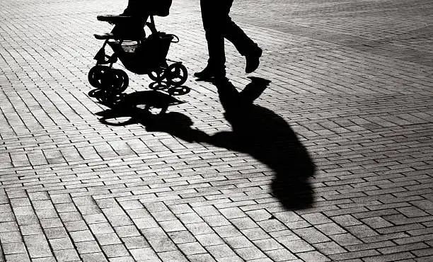 Black And White Shadow Of Baby Stroller On Sidewalk Stones