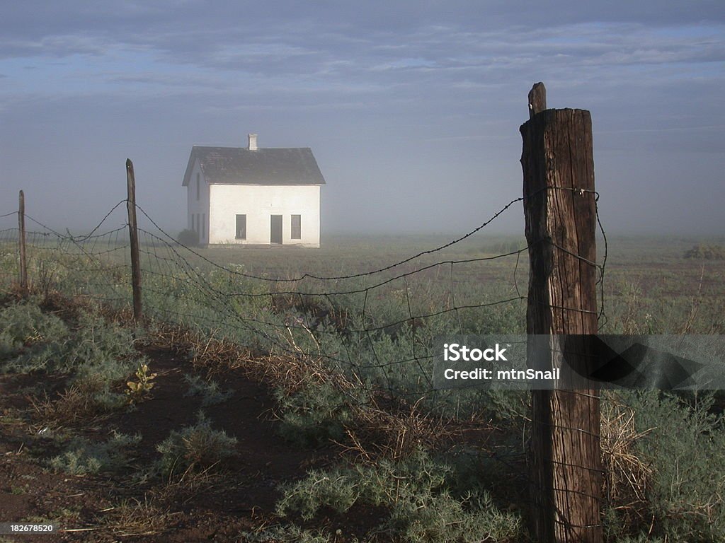 Old farm Early morning sun on an old farmhouse with fence in the foreground. Fence Stock Photo