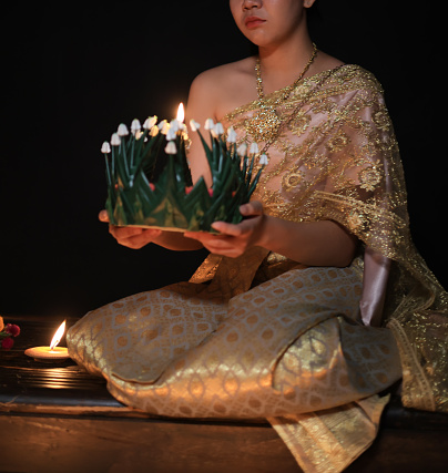 Asian girl with traditional costume hold Krathong to pray respect goodness, Loi Krathong Festival