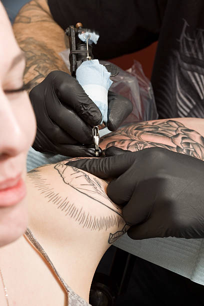 istock Tattoo Artist Tattooing a Female Shoulder 182679285