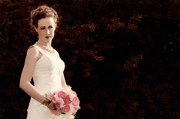 istock Glowing Bride Holding Wedding Bouquet In The Evening Light 182679530