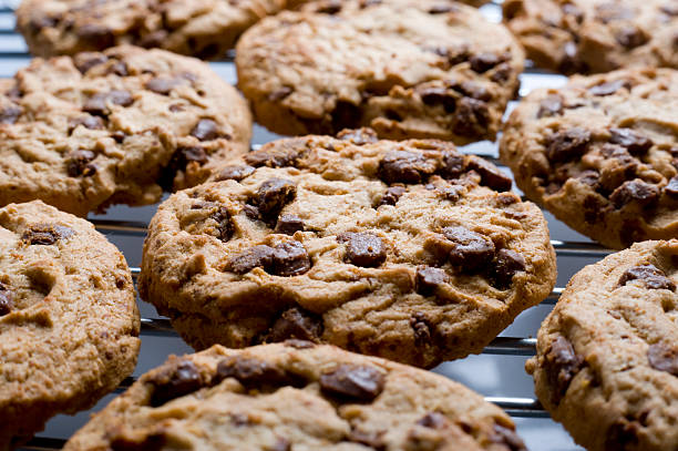 Homemade chocolate chip cookies tied white ribbon with milk on wooden table