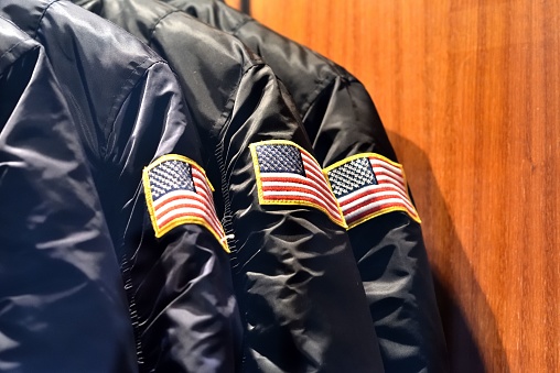 A closeup of black jackets with an American flag