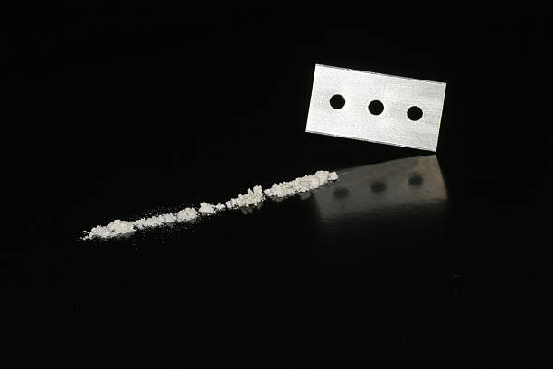 Razorblade and cocaine stock photo