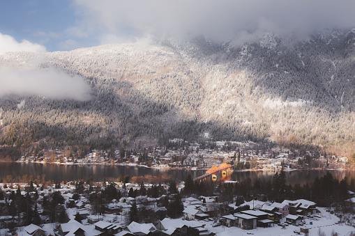 Elevated winter mountain view over the big orange bridge across Kootenay Lake and the Fairview neighbourhood of Nelson, BC, Canada.