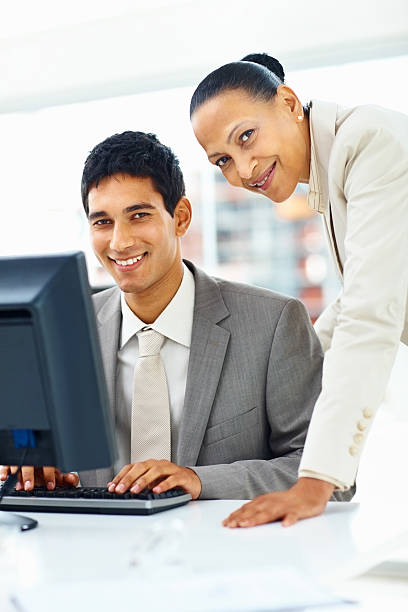 istock Portrait of happy business colleagues working on computer 182681687