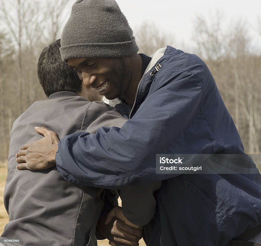 diversity hug african american male and hispanic male hugging:help::help::smile: Adult Stock Photo