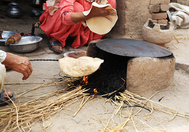 istock Indian Rural Lifestyle Making Chapati Mud Stove 182682123