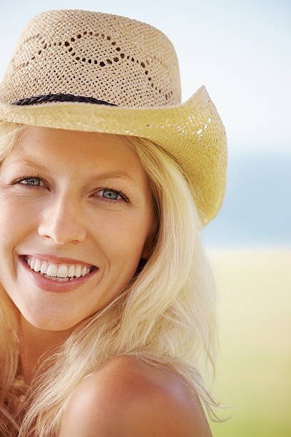istock Young woman smiling in a hat 182682137