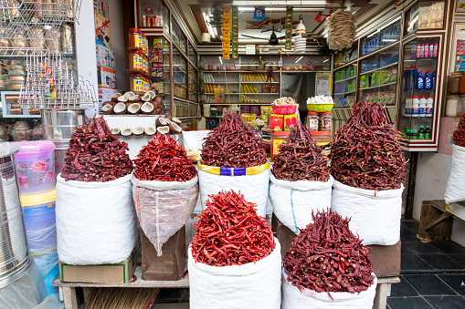 This image vividly brings to life the bustling Spice Market in Mumbai, a sensory-rich destination for both locals and visitors. The market is a mosaic of colours and fragrances featuring a wide variety of spices such as turmeric, cumin, coriander, cardamom, and exotic spice blends that are central to Indian cooking. Notably prominent are the various types of chillis, from fiery red to deep green, adding both heat and depth to the culinary palette. These spices are displayed in heaps and baskets, creating an inviting and aromatic tapestry. This photo aims to showcase the Spice Market as a symbol of Mumbai's rich culinary culture, where every spice and chilli tells a story of tradition, flavour, and the essence of Indian cuisine.