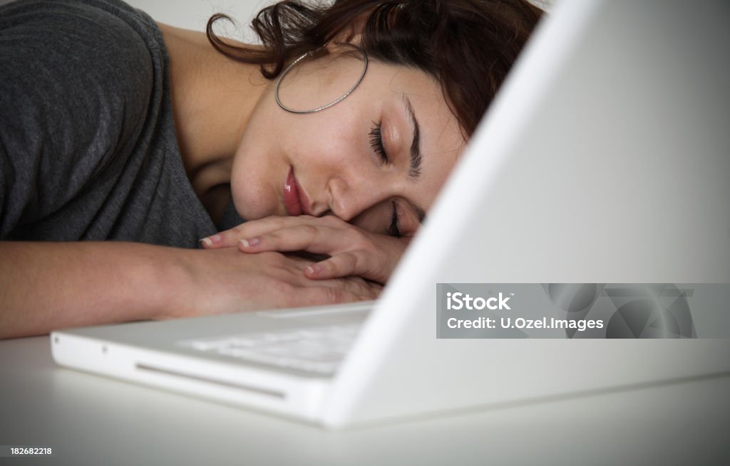 Joven mujer durmiendo en la oficina - Foto de stock de 20 a 29 años libre de derechos