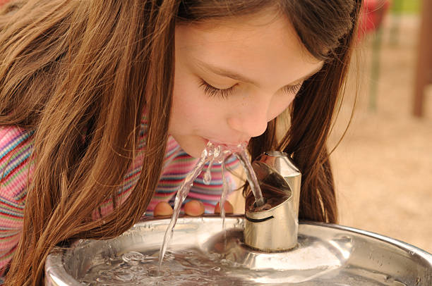 istock Girl quenching her thirst at a drinking fountain 182682505