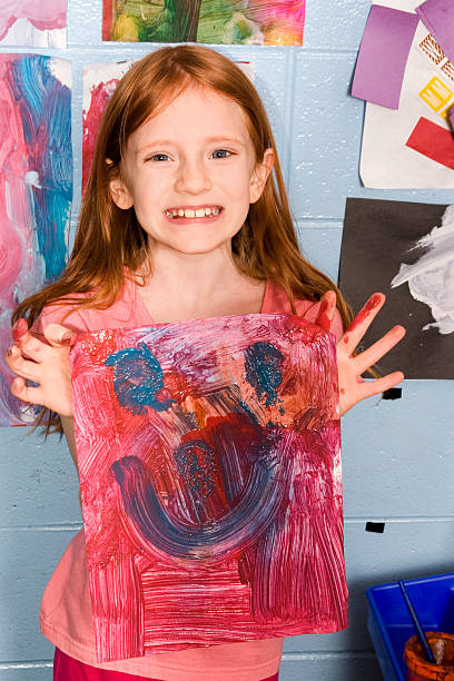 istock Girl holding happy painting 182683316