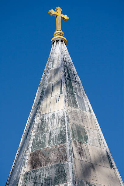 istock Worn Metal Steeple and Yellow Cross 182684812