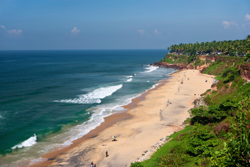 The beach at Mahabalipuram on the Coramandel coast in Tamil Nadu overlooking the Bay of Bengal, with tourist people's bathing in beach.