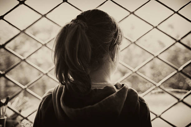 istock Young Girl Looking Out of a Window 182685568